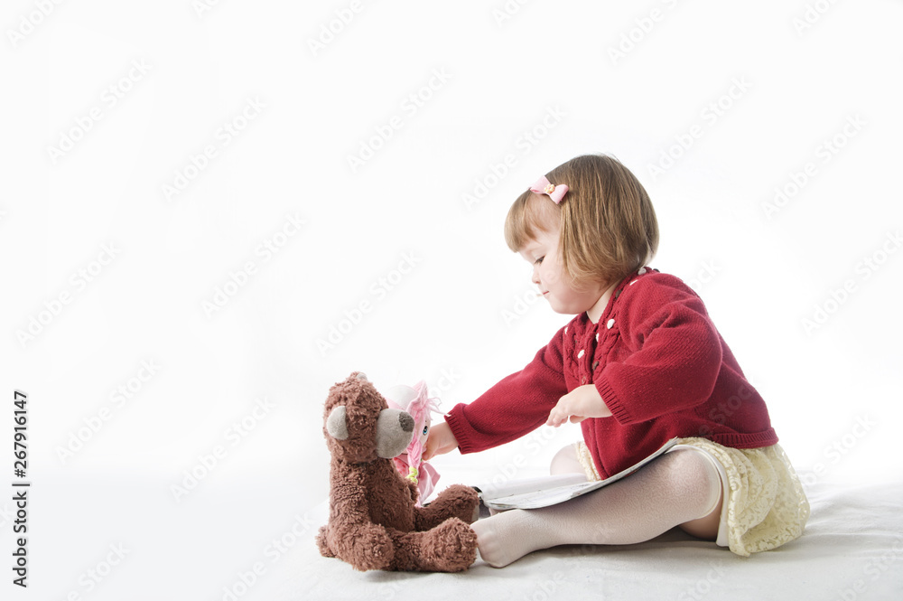 playing little baby girl. elegant blond baby girl with bob hair style. play school with toys: teddy bear and doll playing little baby girl. elegant blond baby girl with bob hair style. play school with toys: teddy bear and doll