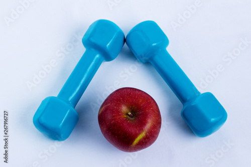 dumbbell and apple white background