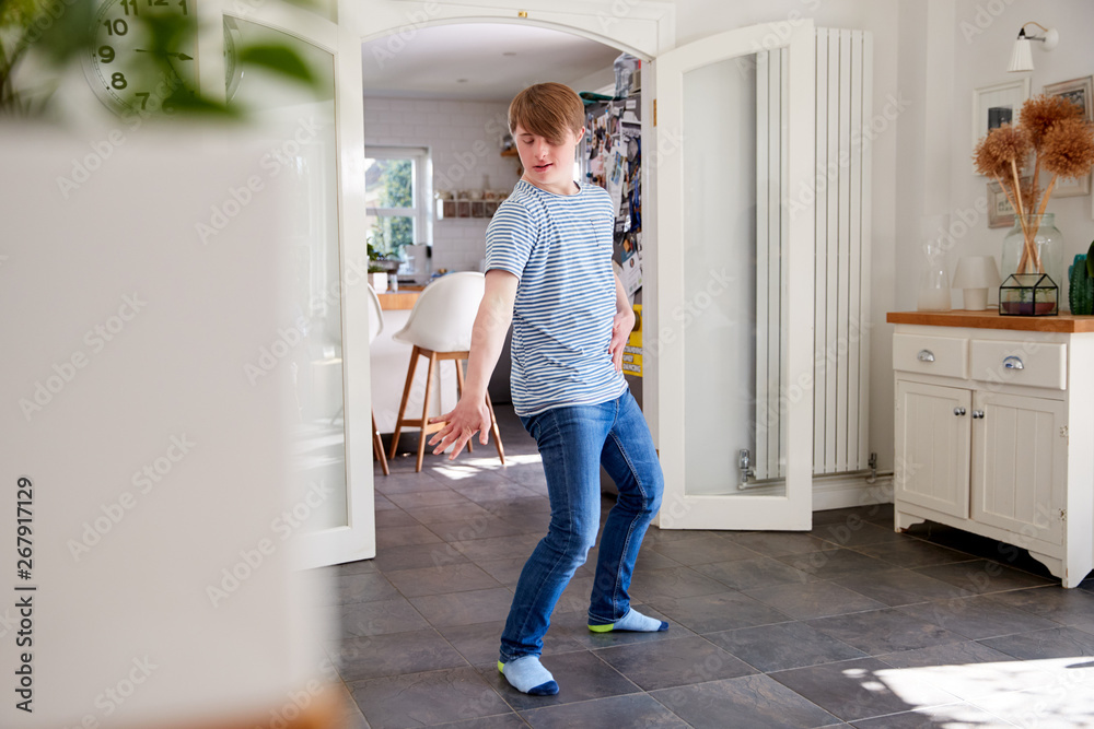 Young Downs Syndrome Man Having Fun Dancing At Home