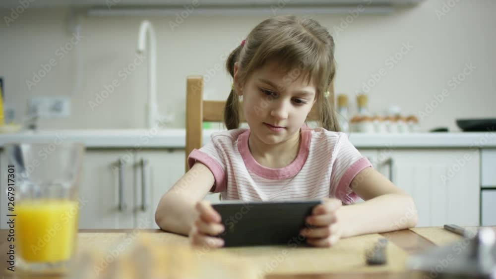 glad girl sitting during the lunch with phone and playing on it glad girl sitting during the lunch with phone and playing on it