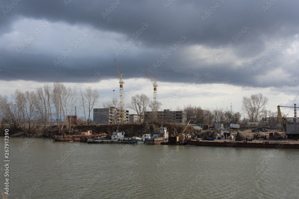 shipyards Zaton in the Gulf of Novosibirsk Ob river Parking of ships and boats boat station under the stormy sky