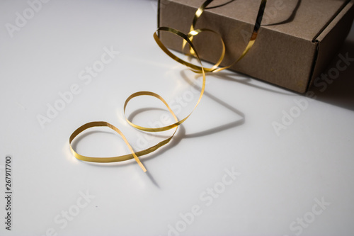 Gift box with golden ribbon close-up - Image