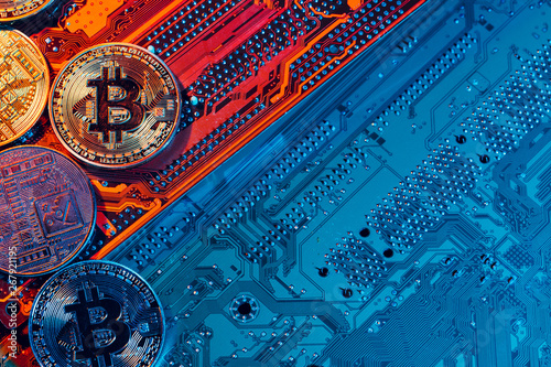 golden bitcoin and computer chip in background photo
