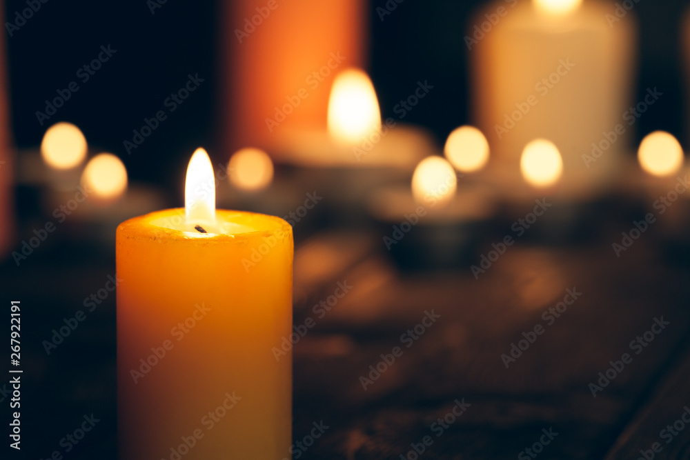 candles burning in darkness over black background. commemoration concept. candles burning in darkness over black background. commemoration concept.