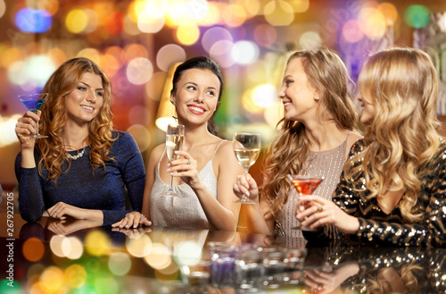 celebration, bachelorette party and holidays concept - happy women or female friends with non-alcoholic drinks in glasses at night club