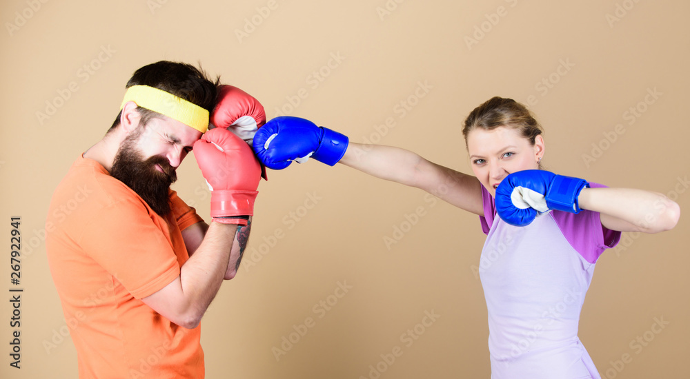 Family battle. Man and woman in boxing gloves. Boxing sport concept. Couple girl and hipster practicing boxing. Sport for everyone. Amateur boxing club. Equal possibilities. Strength and power Family battle. Man and woman in boxing gloves. Boxing sport concept. Couple girl and hipster practicing boxing. Sport for everyone. Amateur boxing club. Equal possibilities. Strength and power