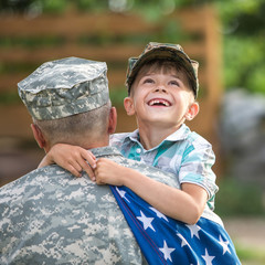 Military man father hugs son. Portrait of happy american family