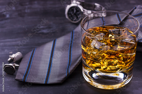 Male concept for father's day. Tie, watches, cufflinks and a glass of whiskey with ice