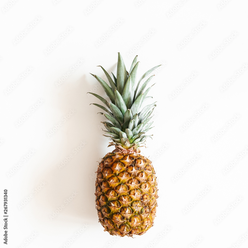 Pineapple on white background. Summer concept. Flat lay, top view, square Pineapple on white background. Summer concept. Flat lay, top view, square