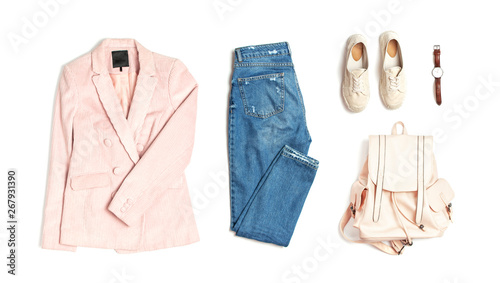 Stylish feminine spring clothing white shirt, blue jeans, pink corduroy jacket, beige espadrilles, backpack, watches on white background. Trendy hipster look. Female background blog concept Flat lay photo