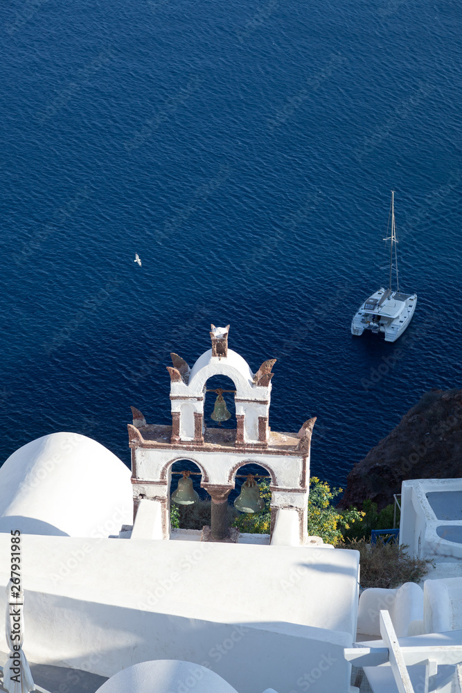 View on the caldera and on a bell in Santorini Oia in summer