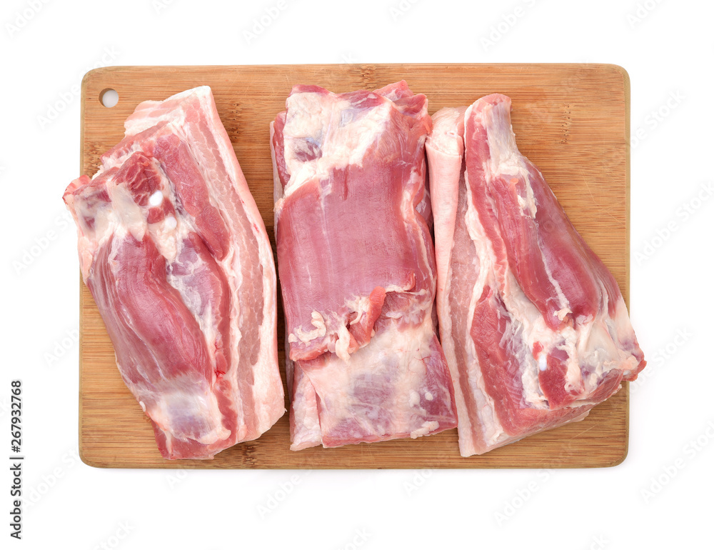 Raw pork belly pieces on a white background