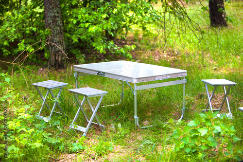 metal folding table and chairs for a picnic in nature