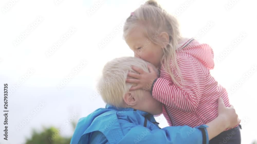 A little girl gently kisses her older brother. Children walk on the street. The little sister hugs the blond boy and kisses him. Children smile and laugh. Spring Cyprus A little girl gently kisses her older brother. Children walk on the street. The little sister hugs the blond boy and kisses him. Children smile and laugh. Spring Cyprus