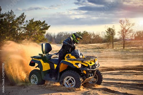 Racing powerful quad bike on the difficult sand in the summer. © trek6500