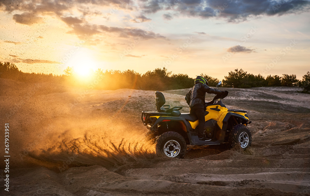 Racing powerful quad bike on the difficult sand in the summer. Racing powerful quad bike on the difficult sand in the summer.