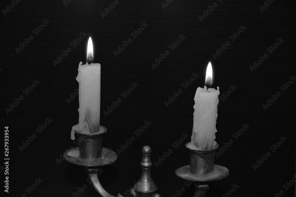 White candles on a black table ( on fire )