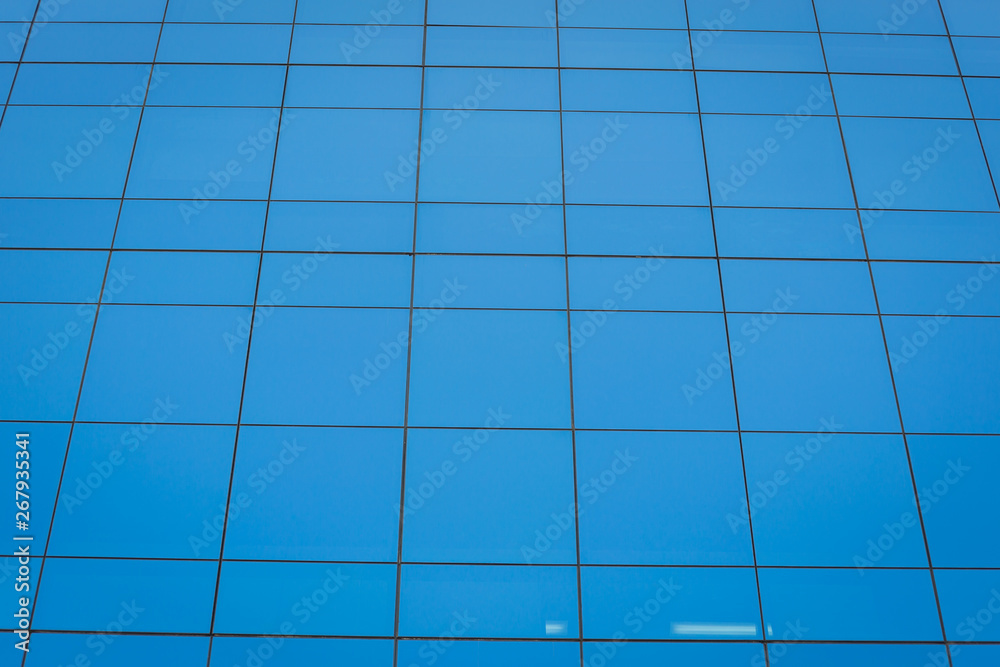 Modern office building with blue glass windows Modern office building with blue glass windows