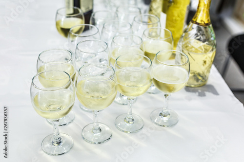 lot of blurred glasses with champagne on the reception party table