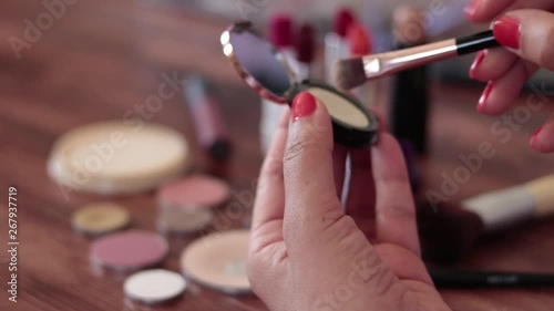 Woman testing face powder on her hand