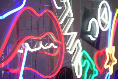 neon glowing wall in the city. beautiful red lips symbol in a nightclub.