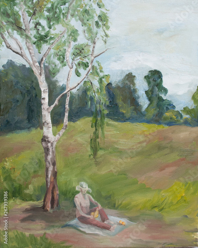 woman reading a book under a Birch tree