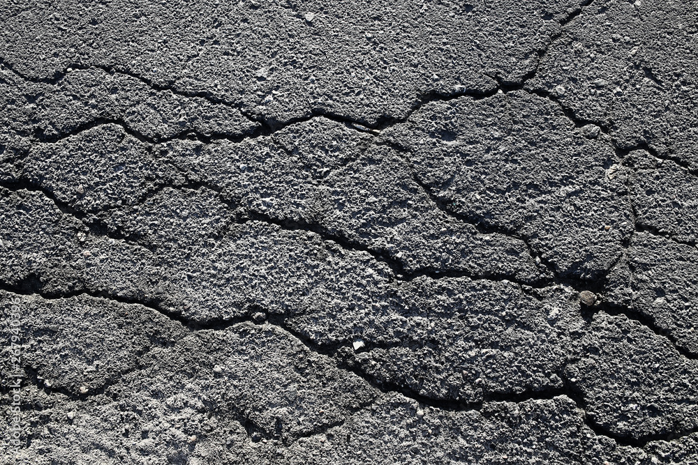 Fototapeta premium asphalt in cracks texture / abstract background cracks on asphalt road