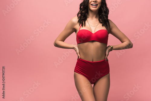 cropped view of smiling attractive woman in swimsuit isolated on pink