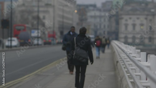Wallpaper Mural A shallow depth of field wide shot of people walking along the side of a bridge next to the road in London Torontodigital.ca