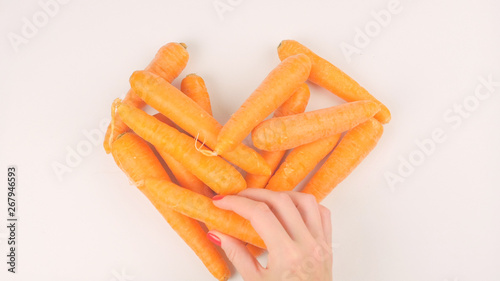 Woman puts carrots in the shape of a heart