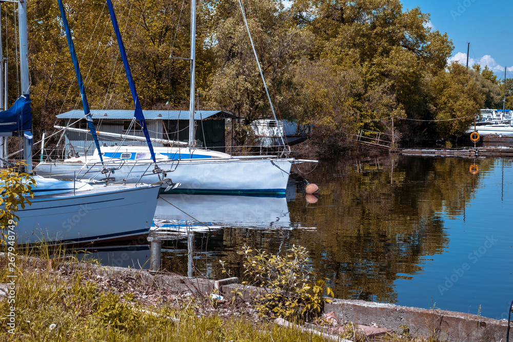 Obraz premium Two white sailing yachts in the bay