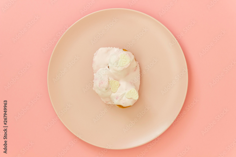 Cake on a pink plate. Pink background. Minimal concept.