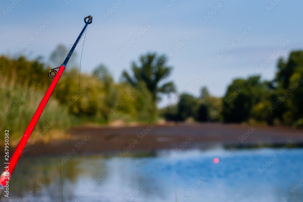 Fishing rod close take with blurred fishing canal Fishing rod close take with blurred fishing canal