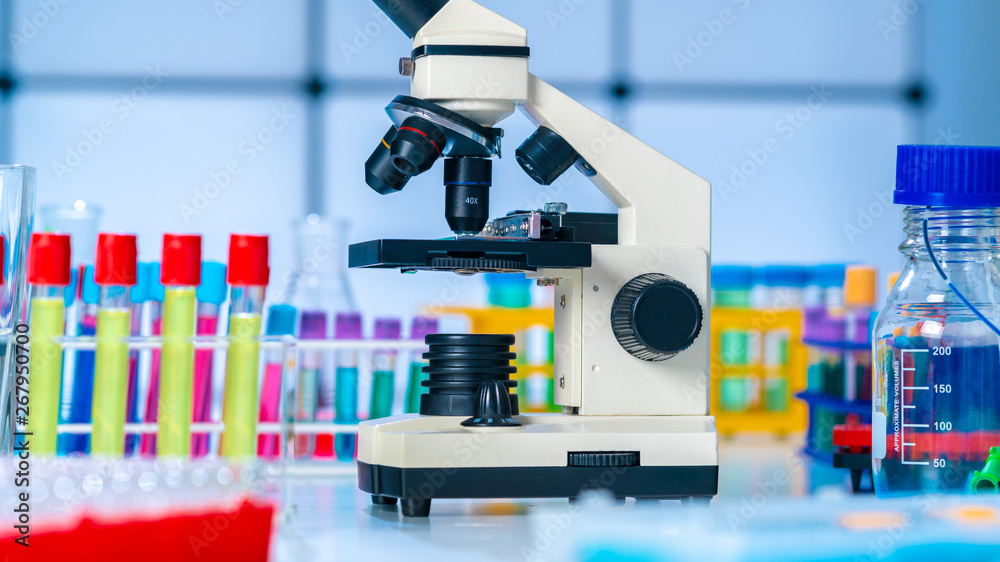 Microscope and test tubes on laboratoy table Microscope and test tubes on laboratoy table