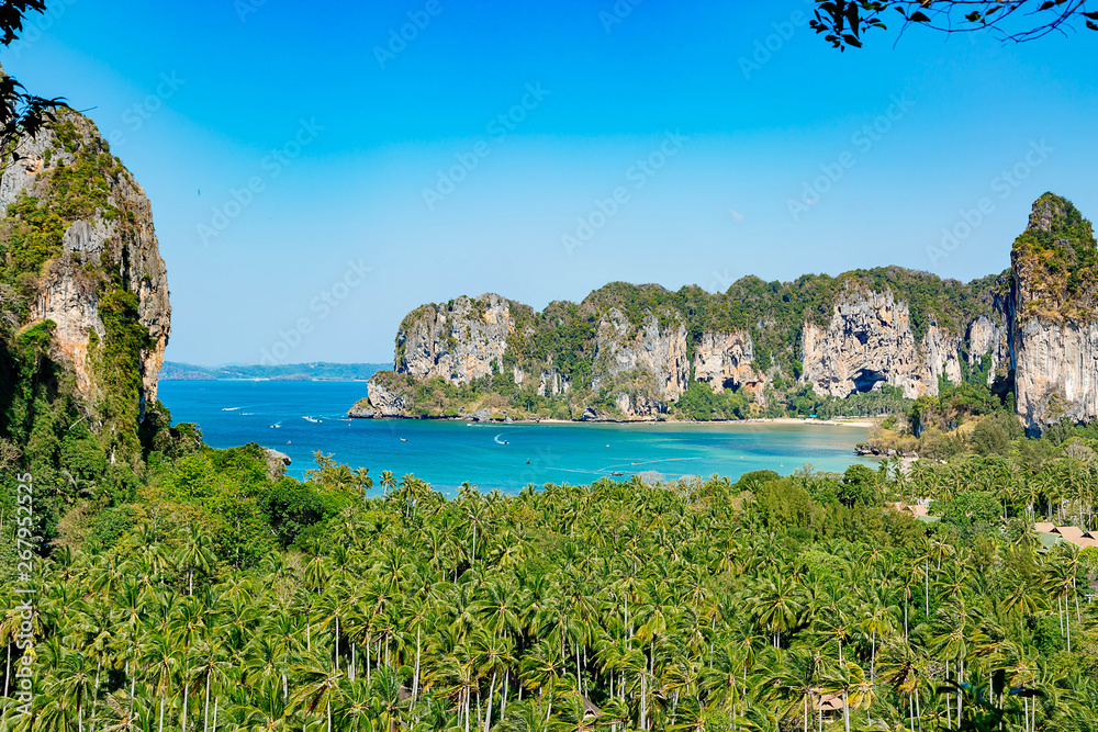 Tropical beach peninsula Railay. View from a lookout point at the mountains, forest and bay. Clear blue sky.Thailand
