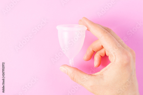 Zero waste concept - menstrual cup on pink background photo