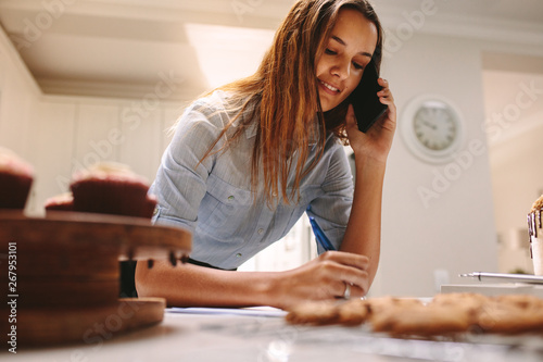 Confectioner taking orders over phone