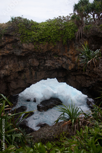 The water rushing in under the Hufangalupe Arch in Tongatapu in Tonga photo