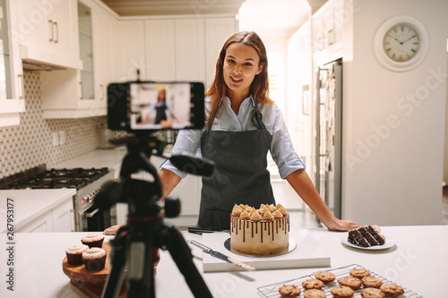 Woman vlogger recording video for food channel photo