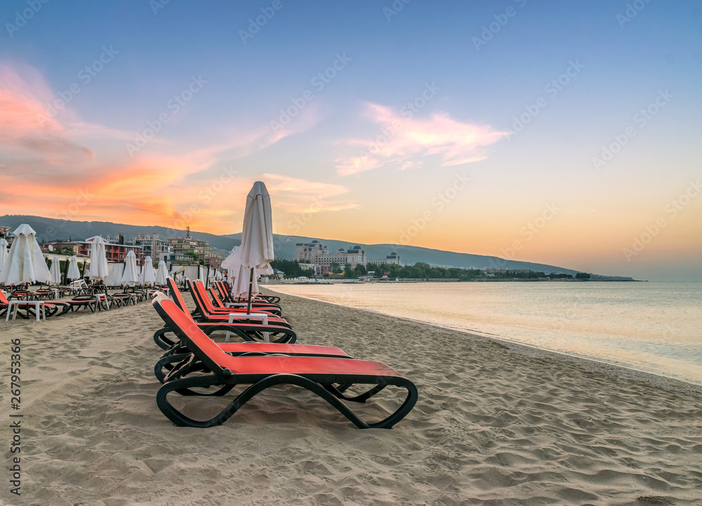 Chairs and umbrellas on a beautiful beach at sunrise in Sunny Beach on the Black Sea coast of Bulgaria