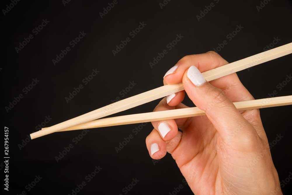 Hand with chopsticks Hand with chopsticks