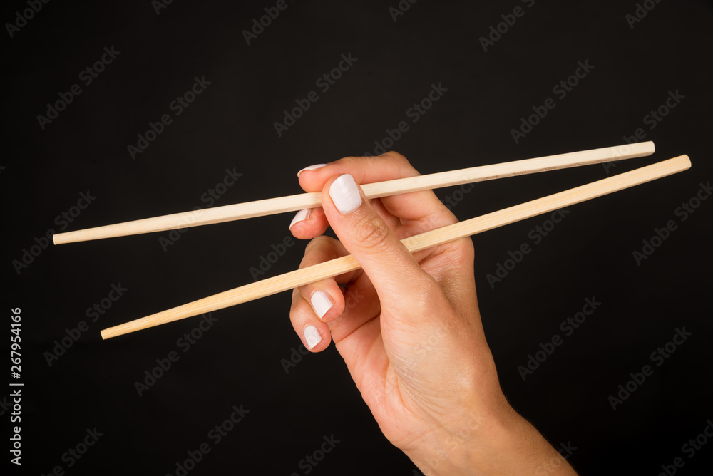 Hand with chopsticks Hand with chopsticks