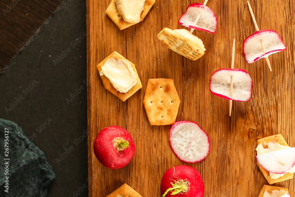 radish, canape appetizer, salad snack with cream cheese, vegetables and herbs (snack). food background. top view radish, canape appetizer, salad snack with cream cheese, vegetables and herbs (snack). food background. top view