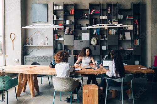 Картината върху платно Young women having meeting in a modern office