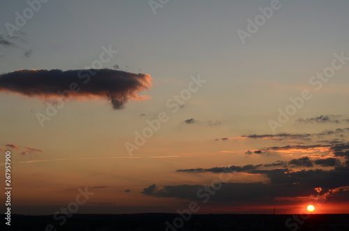 Natural Sunset Sunrise Over Field Or Meadow. Bright Dramatic Sky And Dark Ground. Countryside Landscape Under Scenic Colorful Sky At Sunset Dawn Sunrise. Sun Over Skyline, Horizon. Warm Colours. photo