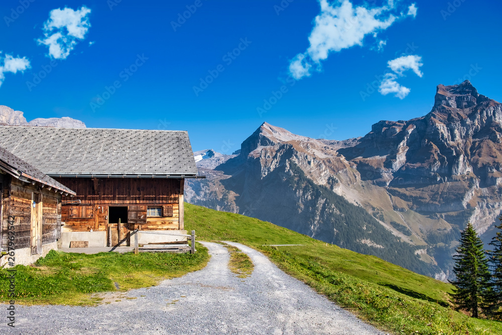 Wooden cottage in swiss mountain landscape