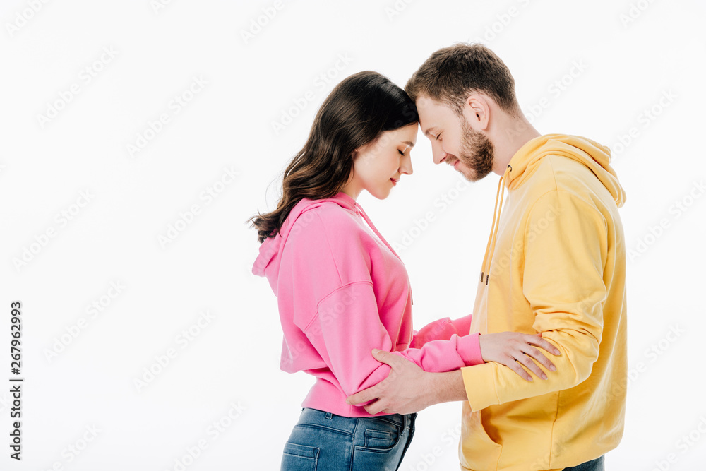 young couple standing face to face with closed eyes isolated on white young couple standing face to face with closed eyes isolated on white