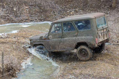  Rally on Russian SUVs in the mud in winter, Trapped all-terrain vehicle pulled out of the river © Mountains Hunter