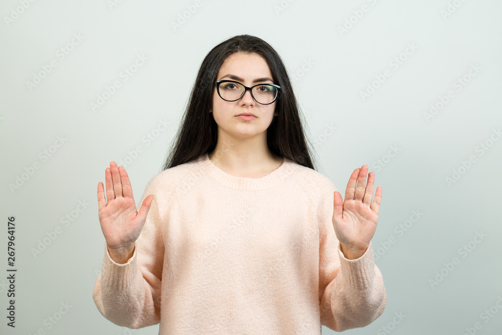 Emotional portrait of a dark-haired girl on a gray background, stormy emotions, business concept. Emotional portrait of a dark-haired girl on a gray background, stormy emotions, business concept.