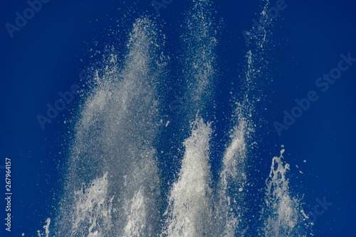 Flying water bursts on blue background